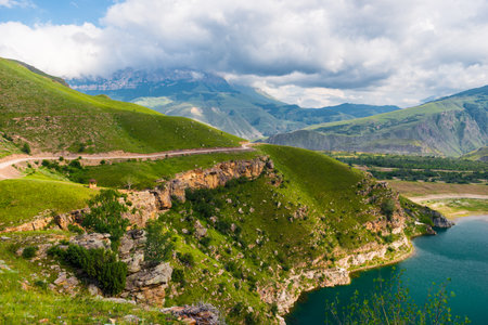 Picturesque view with steep cliffs on the mountain lake Gizhgit with azure water. Caucasusの写真素材