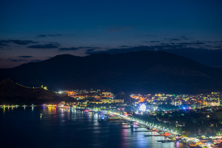 Beautiful view of the night embankment of the city of Sudak after sunset. South coast of the Crimean peninsula. Russiaの写真素材