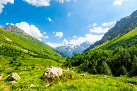Beautiful high mountain landscape with green slopes and large stones. Caucasus, Elbrus region.の写真素材