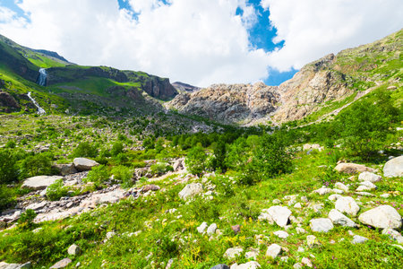 Beautiful high mountain landscape with green slopes and large stones. Caucasus, Elbrus region.の写真素材