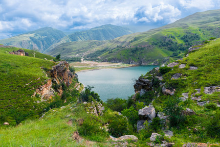 Picturesque view with steep cliffs on the mountain lake Gizhgit with azure water. Caucasusの写真素材