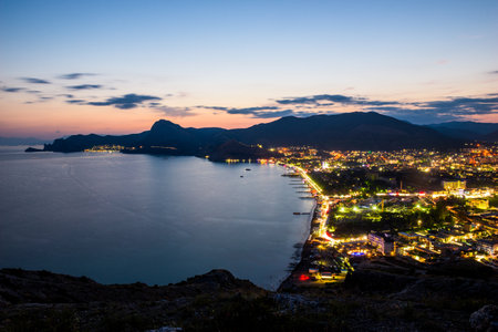 Beautiful view of the night embankment of the city of Sudak after sunset. South coast of the Crimean peninsula. Russiaの写真素材