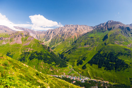 Beautiful picturesque view of a mountain gorge among green mountains in good weatherの写真素材