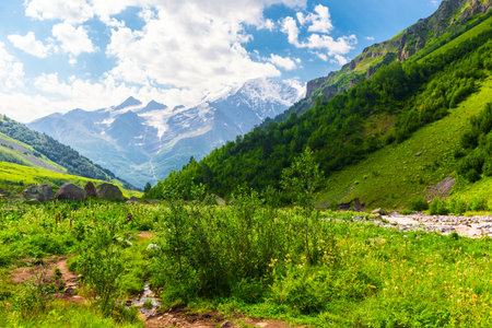 Beautiful high mountain landscape with green slopes and large stones. Caucasus, Elbrus region.の写真素材