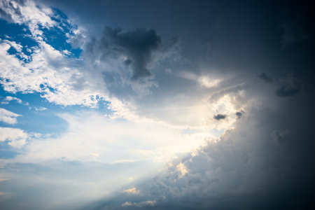 Dramatic stormy sky with rays of sunshineの写真素材
