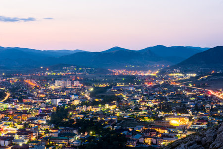 Beautiful night view of Sudak city after sunset. Southern coast of Crimea peninsula. Russiaの写真素材