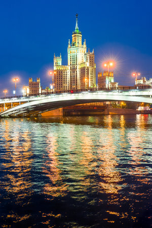 A high-rise building on Kotelnicheskaya embankment and Bolshoy Ustinsky bridge at night. Moscowの写真素材