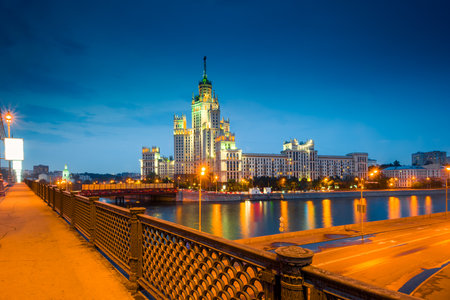 A high-rise building on Kotelnicheskaya embankment and Bolshoy Ustinsky bridge at night. Moscowの写真素材