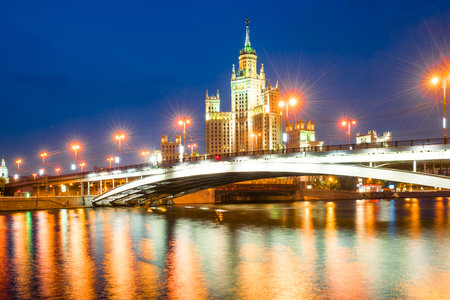 A high-rise building on Kotelnicheskaya embankment and Bolshoy Ustinsky bridge at night. Moscowの写真素材