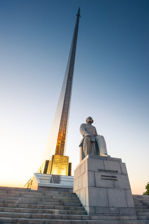 Monument to Tsiolkovsky on the background of the Monument to the Conquerors of Space Museum of Cosmonautics in Moscow in the evening. Russiaの写真素材