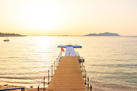 Picturesque landscape of the Red Sea with a pier on a coral reef at dawnの写真素材