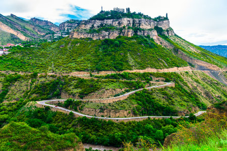 Dramatic view of rocky green mountain with serpentine road. North Caucasusの写真素材
