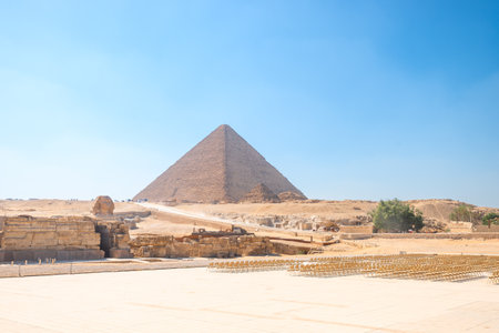 Picturesque landscape with Egyptian Sphinx against the backdrop of ancient pyramids under the scorching sun of the Sahara Desert. Cairoの写真素材