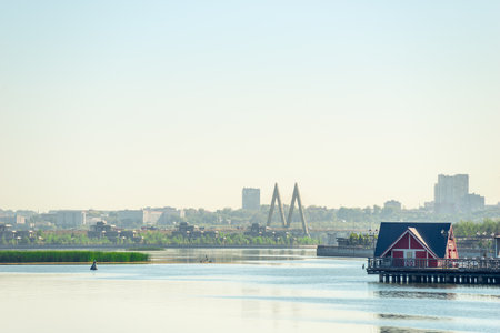Picturesque view of the river Kazanka, a coastal house and a cable-stayed bridge Millennium Bridge. Russiaの写真素材