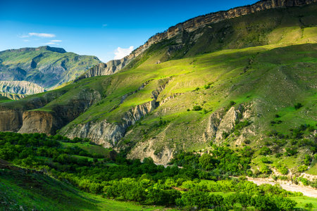 Picturesque mountain landscape with green slope and mountain river at the base of the mountain in Dagestan, Caucasusの写真素材