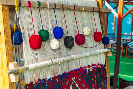 Balls of thread on a primitive loom for handicraftsの写真素材