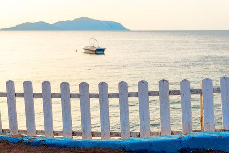 Seascape of Tiran Island in Red Sea with white wooden decorative fence on the shore. Egyptの写真素材