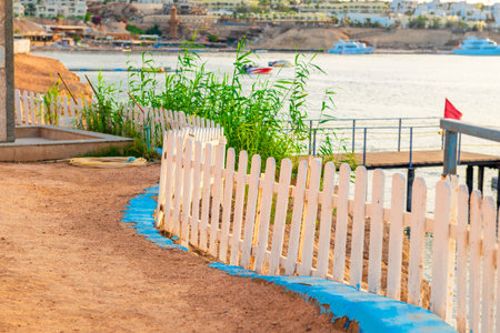 White decorative wooden fence on the path to the beach of the hotel by the sea. Egyptの写真素材