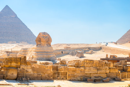 majestic Egyptian sphinx against the backdrop of ancient pyramids under the scorching sun of the...