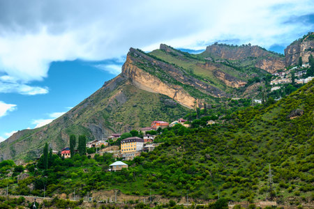 Beautiful landscape with rocky peak and mountain settlement in the mountains of the North Caucasus. Dagestanの写真素材