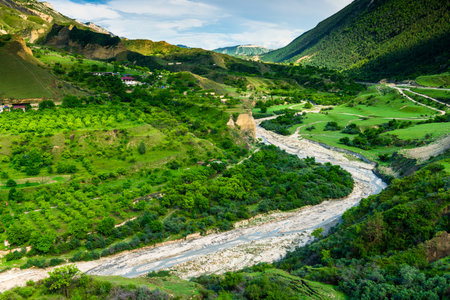 Picturesque mountain landscape with a winding mountain river and fruit gardens. Dagestan, Caucasus