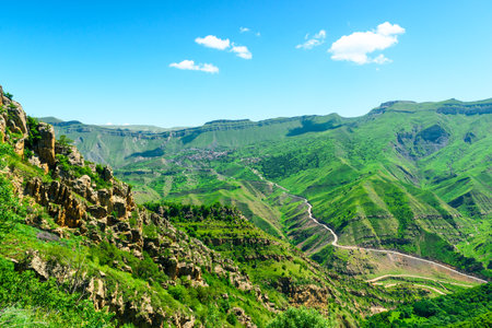 Picturesque landscape of green mountain slope with rock formations. North Caucasus