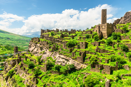 Ruins of the old village of Kakhib on a green mountain slope. North Caucasusの写真素材