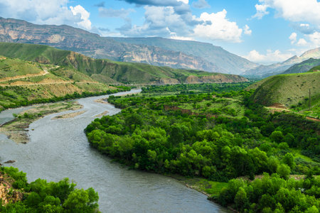 Picturesque landscape with a turbulent flow of a mountain river among beautiful mountains. North Caucasusの写真素材