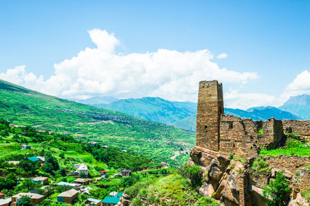 An old watchtower among the ruins of the abandoned mountain village of Kakhib on a mountainside. North Caucasusの写真素材