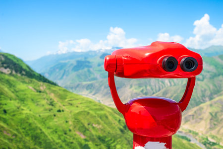 Red binoculars overlooking a mountain canyon. North Caucasusの写真素材