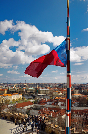 Czech flag fluttering in the background of the old city of Pragueの写真素材