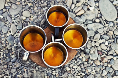 Four mugs with drink in sea coast, party of friends, top view.の写真素材