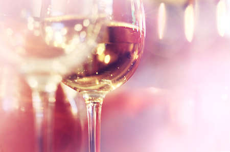 A pair glasses of wine on light bokeh background with copy space for text. Party theme.の写真素材