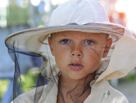 Portrait of a little boy beekeeper. beekeepingの写真素材