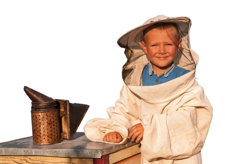 beekeeper a young boy who works in the apiary. Isolated on white background.の写真素材
