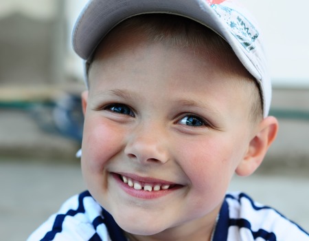 Funny boy with blue eyes and a smile on his face. Emotions.