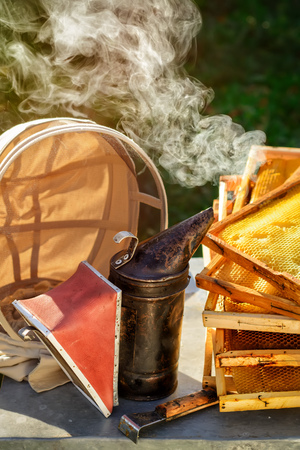 Old bee smoker. Beekeeping tool. Autumn in an apiary. Theme of beekeepingの写真素材