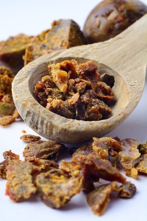 Propolis granules in a wooden spoon. Bee glue. Bee products. Apitherapy. Apiculture.の写真素材