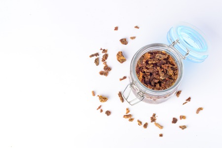 Glass jar with propolis granules. Bee glue. Bee products. Apitherapy. Apiculture.の写真素材