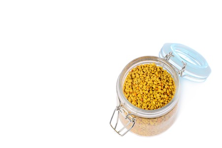 Flower pollen in a glass jar is isolated on a white background. Natural remedy for immunity enhancement. Beekeeping products. Apitherapy.の写真素材