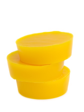 Pieces of natural beeswax are isolated on a white background. Beekeeping products. Apitherapy.の写真素材