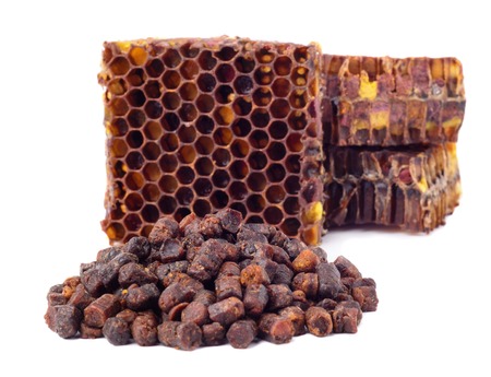 Bee granules and a piece of honey cells are isolated on a white background. Natural remedy for immunity enhancement. Beekeeping products. Apitherapyの写真素材