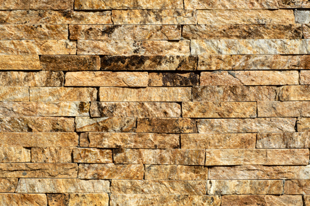 Stone wall of natural stones in different sizes. The facade of the houseの写真素材