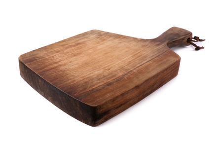 Old wooden cutting board on a white background.の写真素材