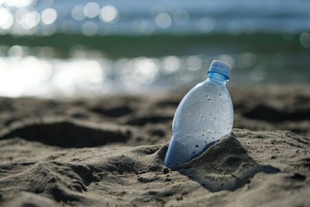 Plastic bottle is on the beach leave by tourist. The problem of pollution of the waters of the oceans with plastic. The concept of abandoning plastic.の写真素材