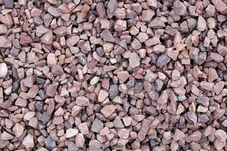 Decorative stone building pebbles close-up macro photo stone designer background. Red Marble crumb. Pebble.の写真素材