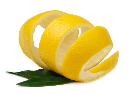 Useful properties of lemon peel. Lemon peel with green lemon leaves isolated on a white background. Use of lemon peel in cooking and medicineの写真素材