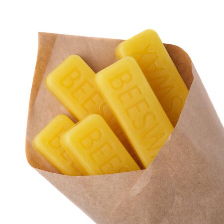 Beeswax wrapped in kraft paper on a white background. Beeswax blocks. Natural beeswax.の写真素材