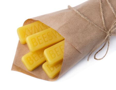 Beeswax wrapped in kraft paper on a white background. Beeswax blocks. Natural beeswax.の写真素材