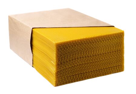 Beeswax. Wax base for honey bee rebuilding on a white background. Honeycombs.の写真素材
